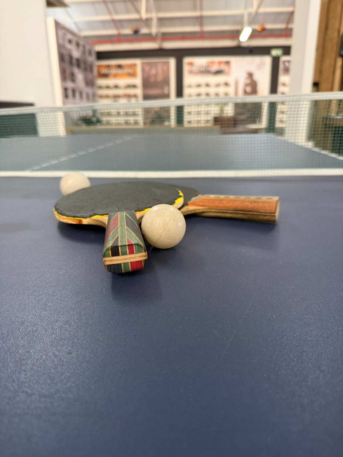 Bats and balls on the showroom table tennis table